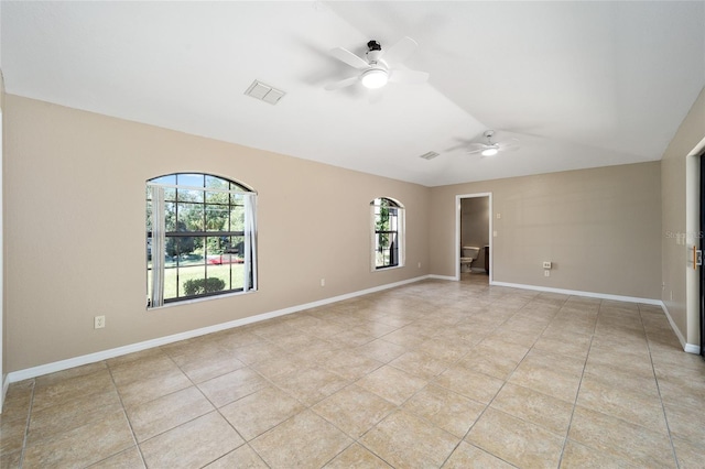 spare room featuring ceiling fan, vaulted ceiling, and light tile patterned flooring