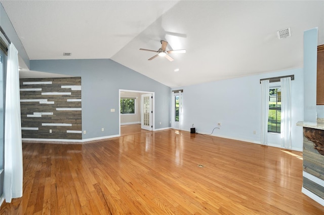 unfurnished living room featuring ceiling fan, wood-type flooring, and lofted ceiling