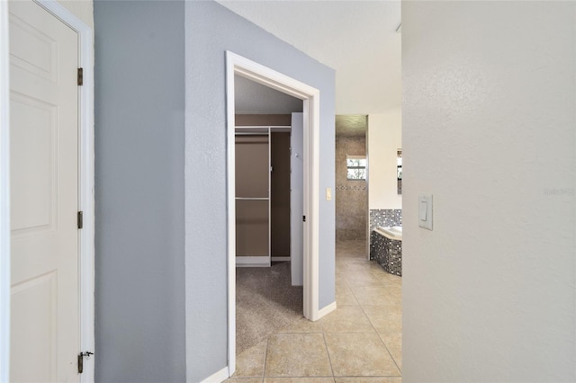 hallway with light tile patterned flooring