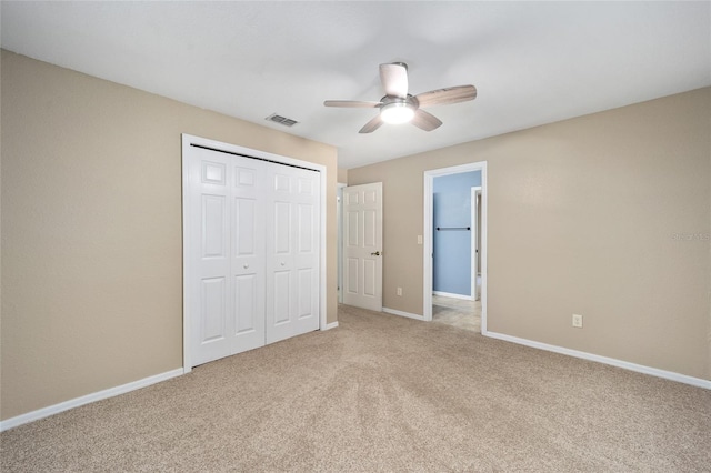 unfurnished bedroom featuring ceiling fan, a closet, and carpet floors