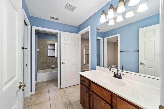 bathroom featuring vanity, tiled shower / bath combo, and tile patterned floors