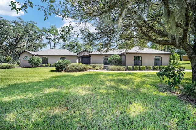 ranch-style home featuring a front yard