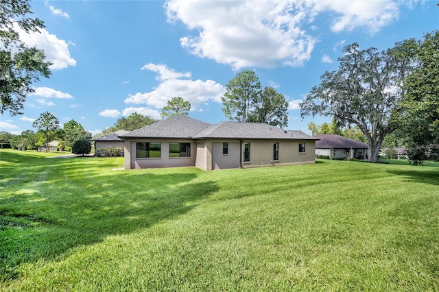 rear view of house with a yard