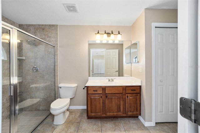 bathroom with toilet, a shower with shower door, and vanity