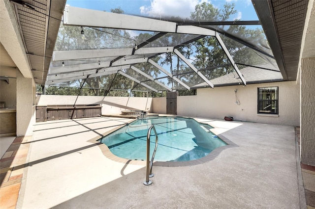 view of pool featuring a lanai, a hot tub, and a patio area