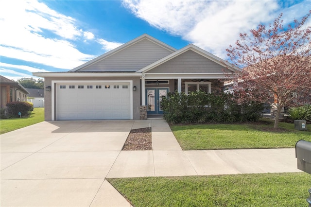 view of front of home featuring a front lawn and a garage