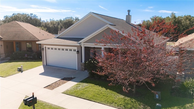 view of front of property with a front yard and a garage