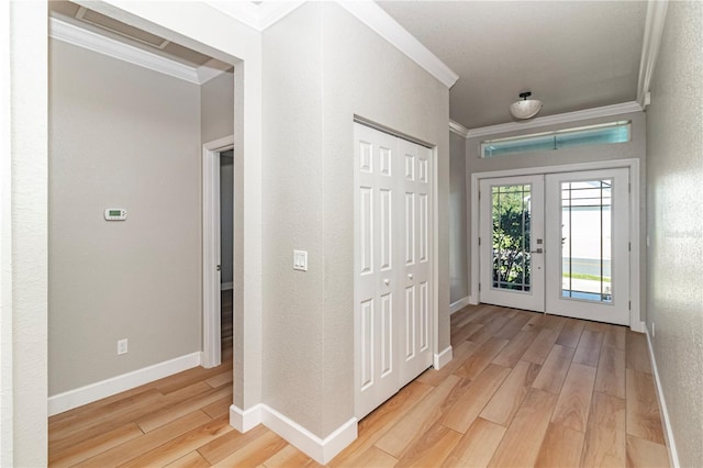 entryway featuring french doors, light hardwood / wood-style flooring, and ornamental molding