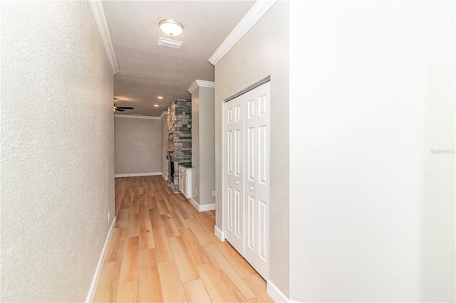 hallway featuring wood-type flooring and crown molding