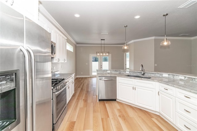 kitchen featuring light stone counters, sink, white cabinetry, stainless steel appliances, and light wood-type flooring