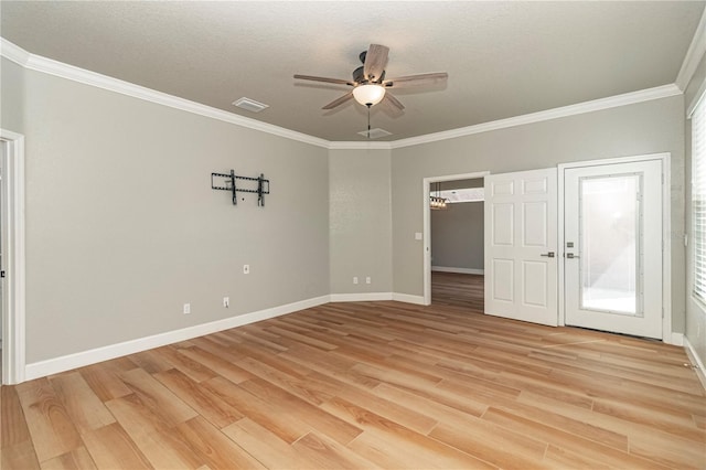 spare room featuring light wood-type flooring, ceiling fan, and crown molding