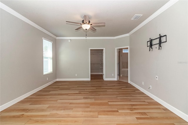 spare room featuring light hardwood / wood-style floors, ornamental molding, and ceiling fan