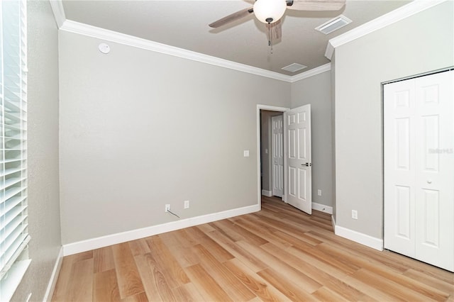 unfurnished bedroom featuring wood-type flooring, ornamental molding, ceiling fan, and a closet