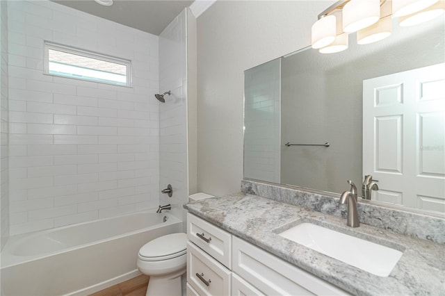 full bathroom featuring vanity, toilet, and tiled shower / bath