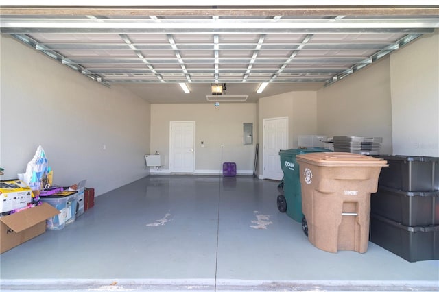 garage with a garage door opener and electric panel