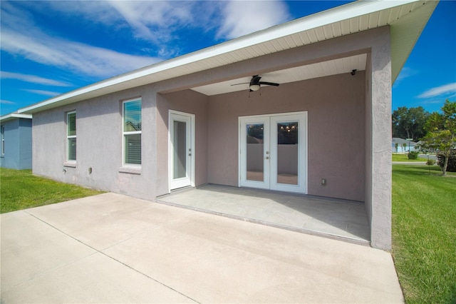 rear view of property featuring ceiling fan, a patio area, french doors, and a yard