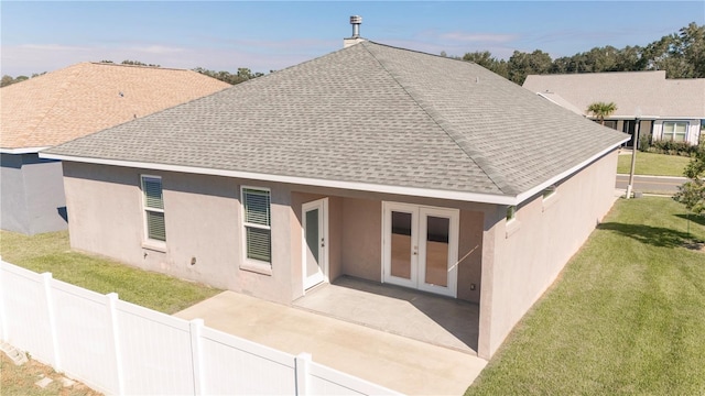 back of house with a lawn, a patio, and french doors