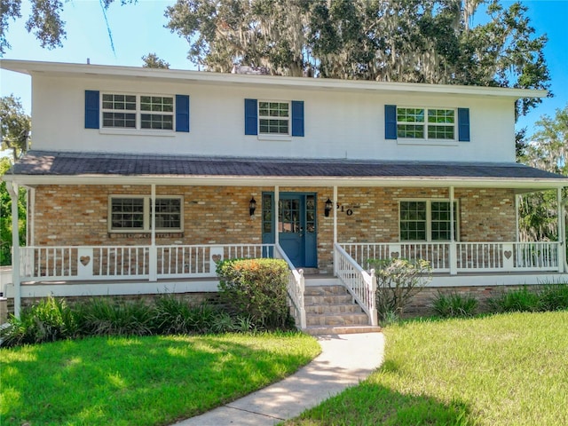 view of front of home featuring a front yard and a porch