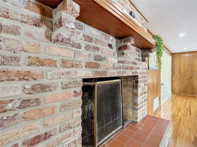 interior details featuring wood-type flooring and a fireplace