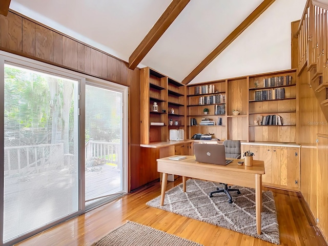 office space featuring wood walls, beam ceiling, hardwood / wood-style floors, and high vaulted ceiling