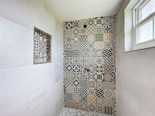 bathroom with tiled shower