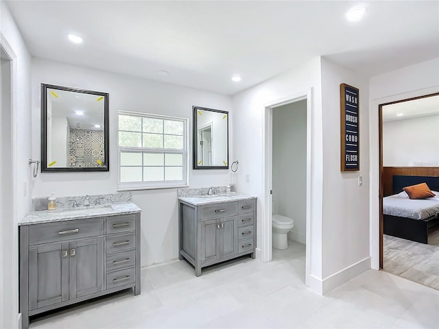 bathroom featuring hardwood / wood-style flooring, vanity, and toilet