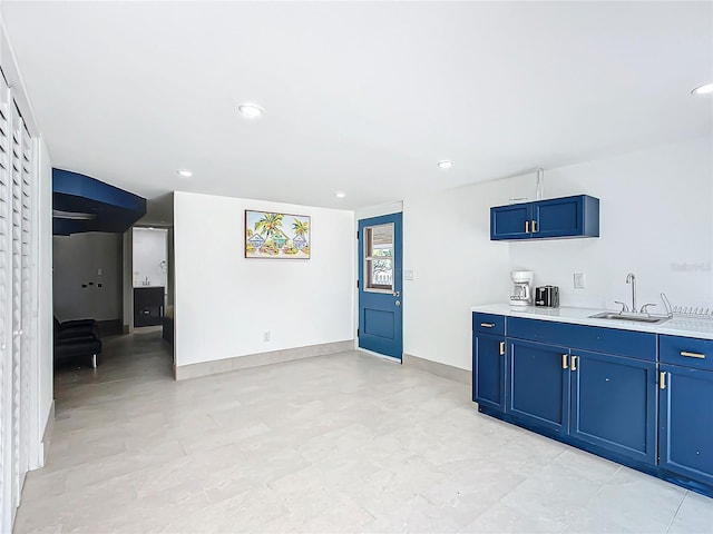 kitchen featuring sink and blue cabinetry