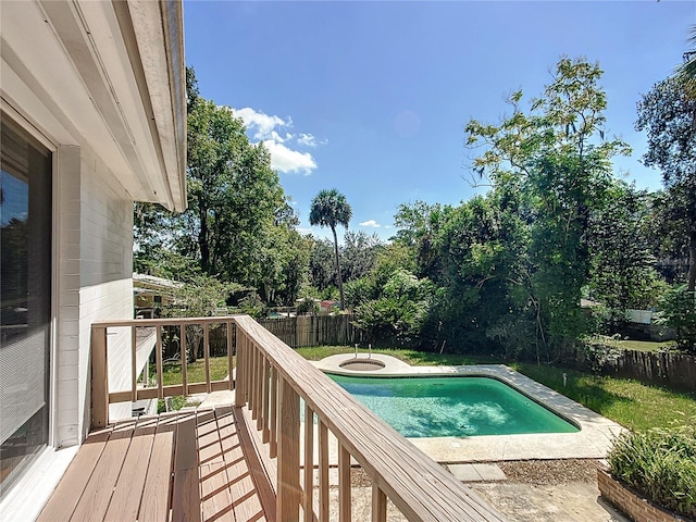 view of swimming pool with a deck