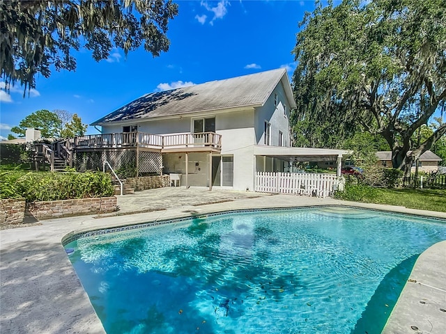 back of house featuring a patio area and a swimming pool side deck