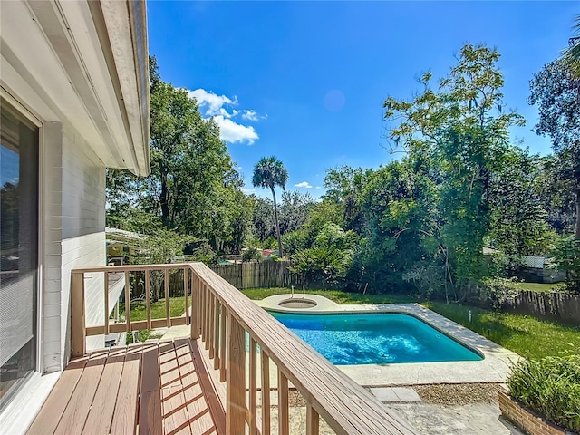 view of swimming pool featuring a yard and a wooden deck