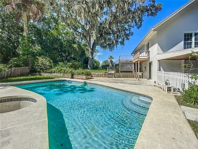 view of pool with a hot tub and a patio area