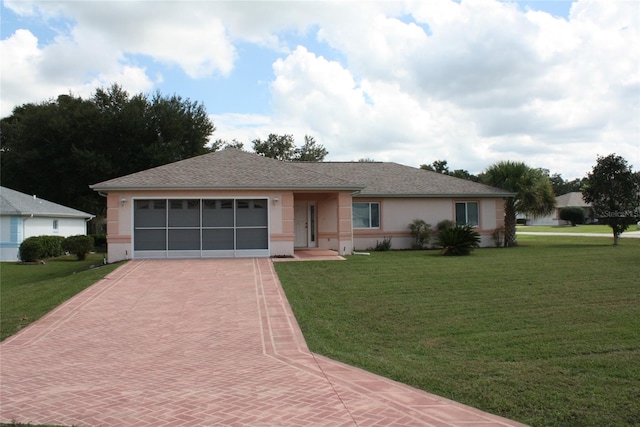 ranch-style house featuring a front lawn and a garage