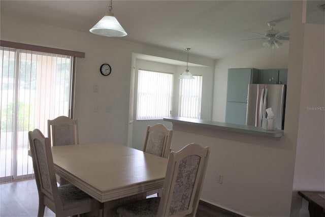 dining space with lofted ceiling, hardwood / wood-style floors, and ceiling fan