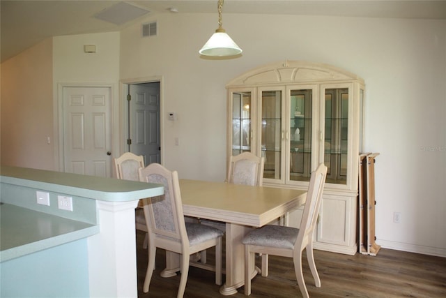 dining room with lofted ceiling and dark hardwood / wood-style floors