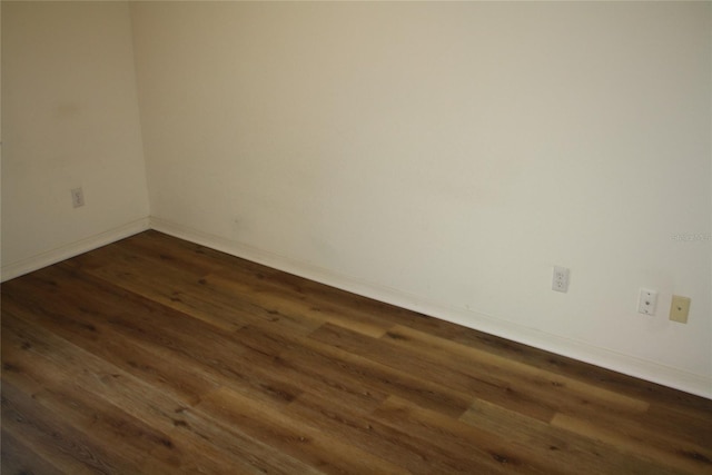 spare room featuring dark hardwood / wood-style flooring