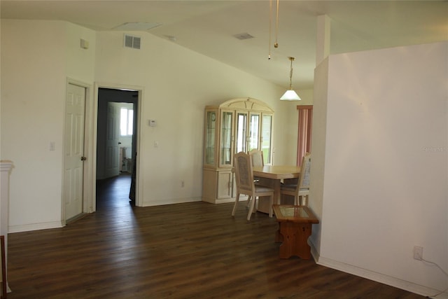 dining room with vaulted ceiling and dark hardwood / wood-style flooring