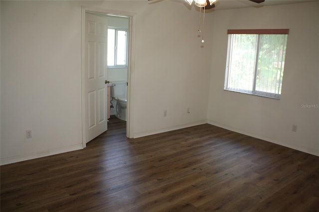 unfurnished room featuring dark hardwood / wood-style floors and ceiling fan