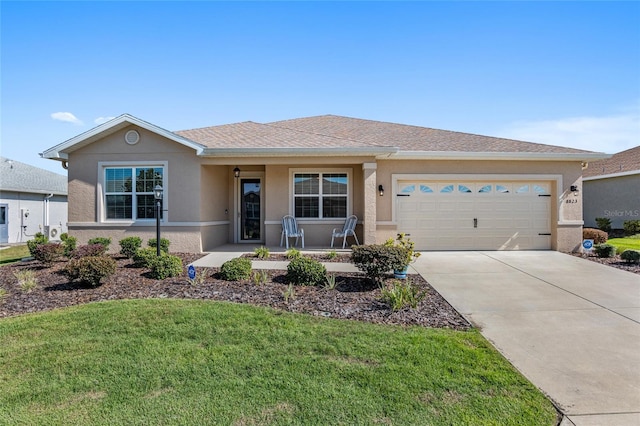 ranch-style home with a front yard and a garage