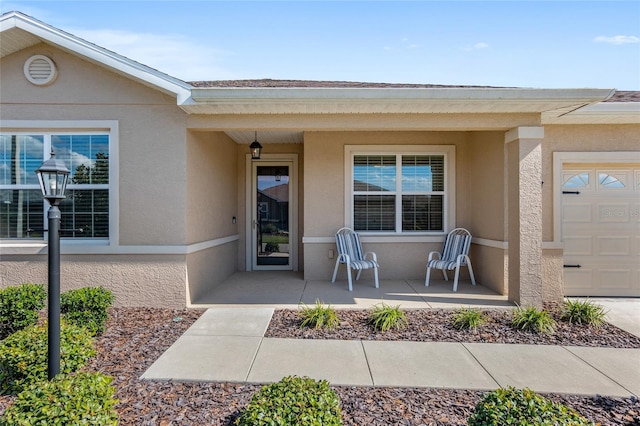 view of exterior entry with a garage