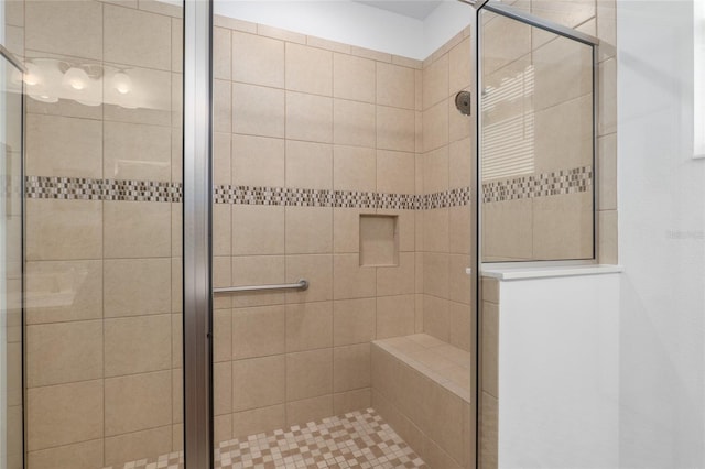 bathroom featuring a shower with door