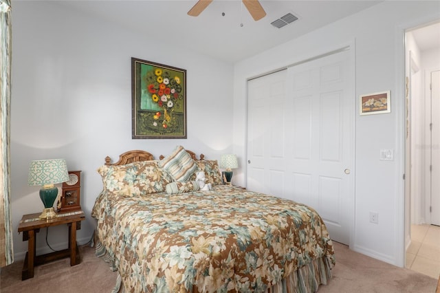 carpeted bedroom featuring ceiling fan and a closet