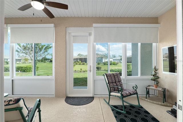 sunroom / solarium with ceiling fan and wood ceiling