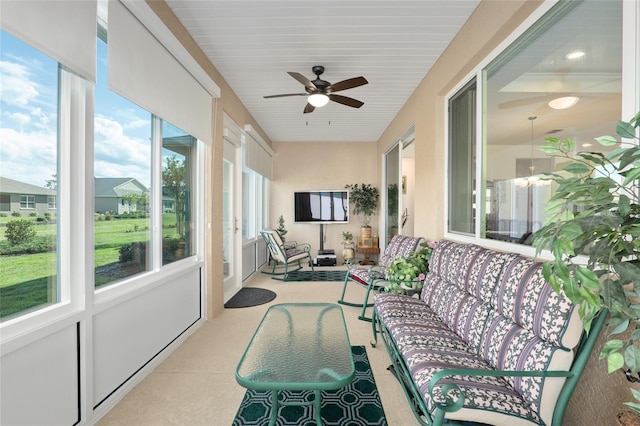 sunroom featuring ceiling fan