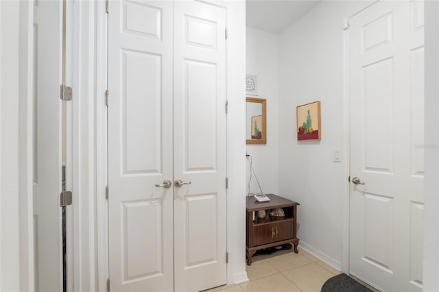 hall with light tile patterned floors