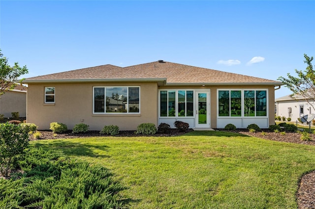 rear view of house with a lawn