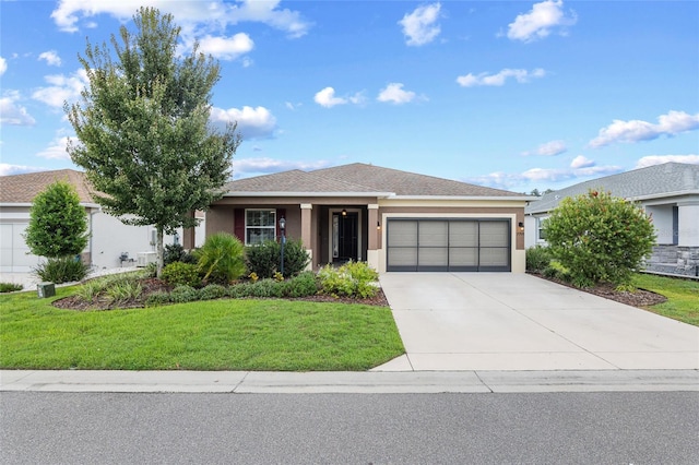 view of front of home featuring a garage and a front lawn