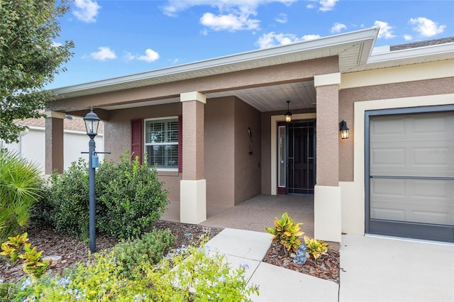 7709 SW 86th Ct, Ocala, FL 34481 - property entrance featuring stucco siding and an attached garage