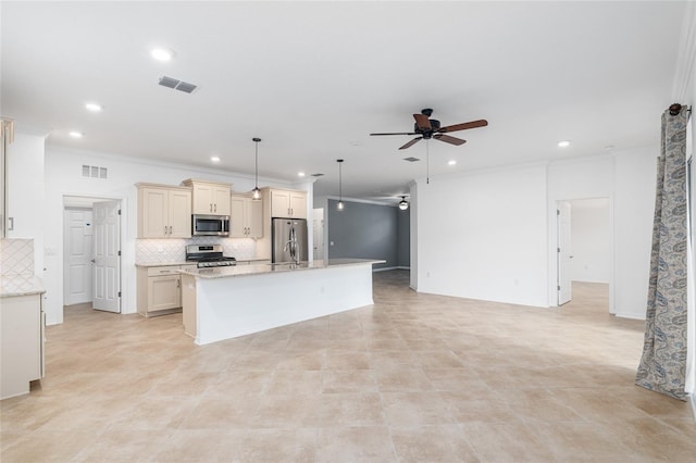 kitchen featuring hanging light fixtures, a kitchen island, backsplash, appliances with stainless steel finishes, and light stone countertops