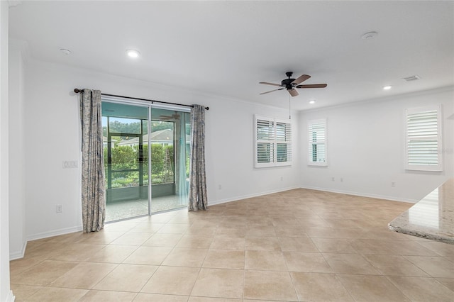 unfurnished room with ceiling fan, light tile patterned floors, plenty of natural light, and ornamental molding