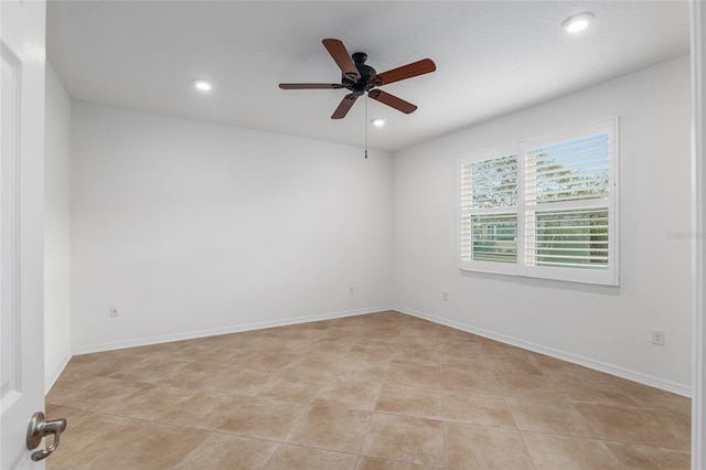 tiled empty room featuring ceiling fan